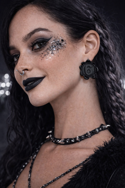 Black number 6 statement earrings worn with gothic rave makeup and black outfit