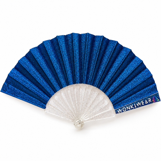 Cobalt blue glitter folding hand fan with clear transparent ribs and WonkiWear branding on a white background.