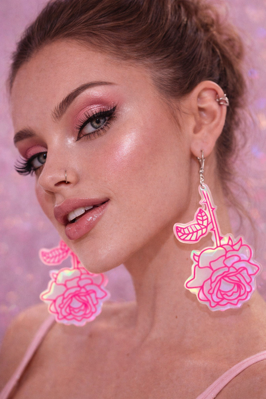 Model wearing rose earrings pink floral statement