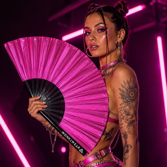 Festival model holding XL hot pink shimmer metallic festival fan during studio photoshoot