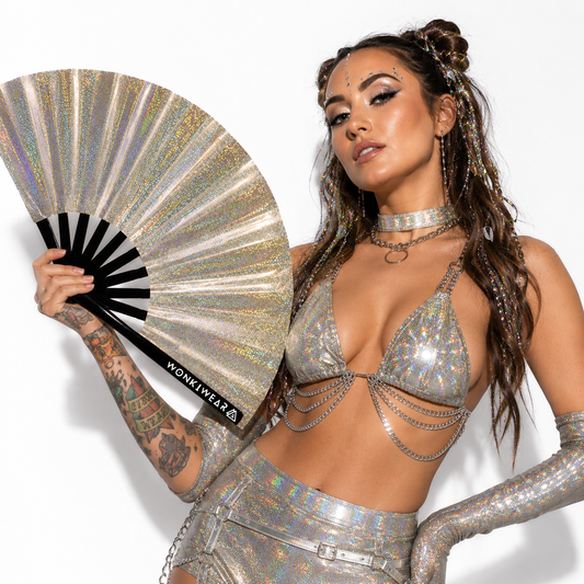 Festival model holding Jupiter Galaxy holographic champagne gold fan in a studio photoshoot