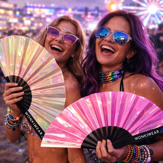 Festival girls holding pearl and pink iridescent rave fans at a music festival, colourful nightlife vibe