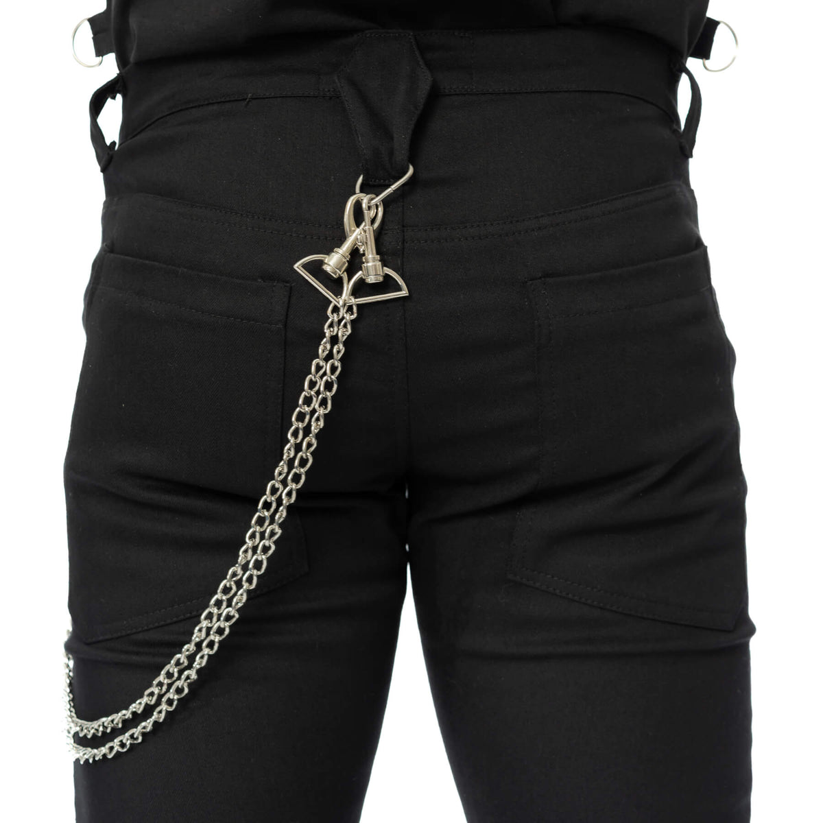 Rear close-up of black alternative trousers showing the decorative metal chain