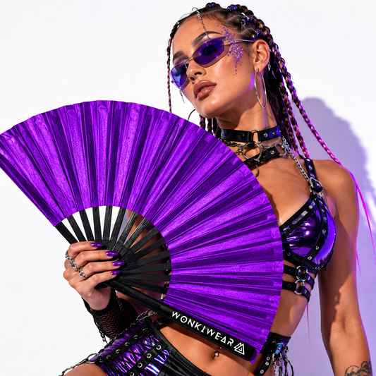 Festival model holding XL purple shimmer metallic festival fan during studio photoshoot