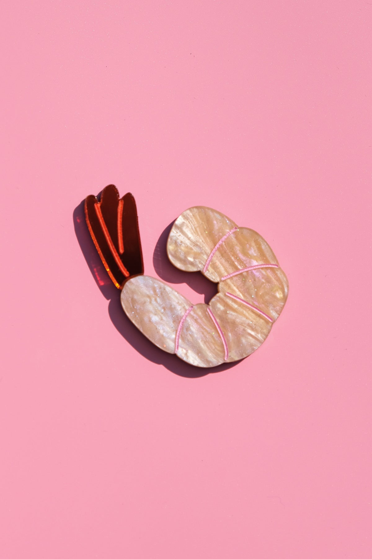 Shrimp hair clip featuring a shimmery peeled prawn design by Cuteryko