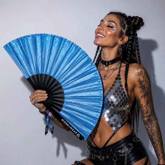 Festival model holding XL sky blue shimmer metallic festival fan during studio photoshoot