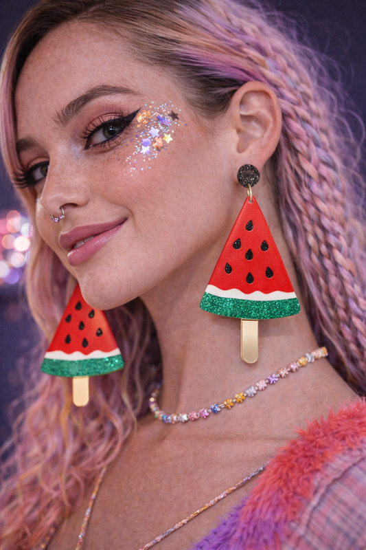 Watermelon drop earrings worn with colourful festival makeup and outfit