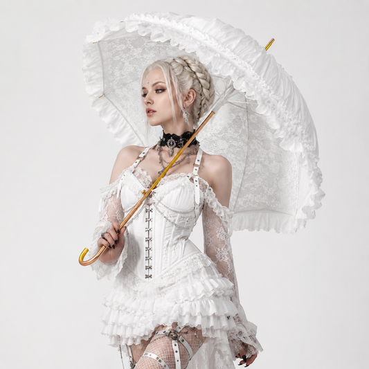 Alternative bride holding white Victorian lace umbrella in gothic inspired fashion shoot