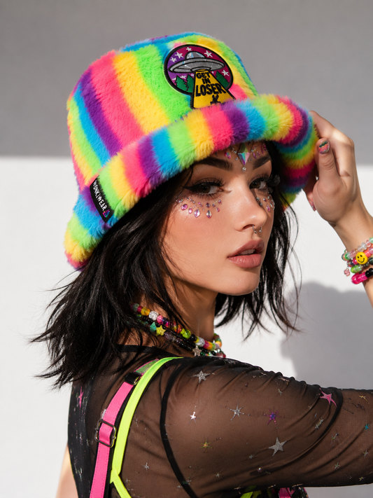 Festival model wearing neon rainbow furry bucket hat
