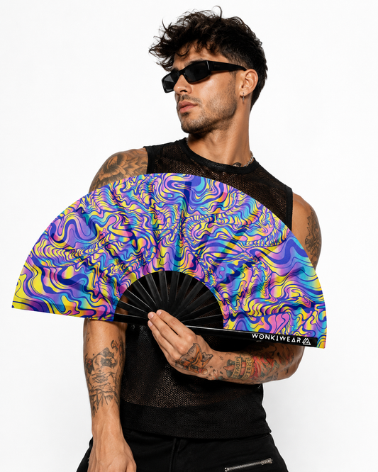 Male festival model holding XL UV reactive psychedelic rave fan