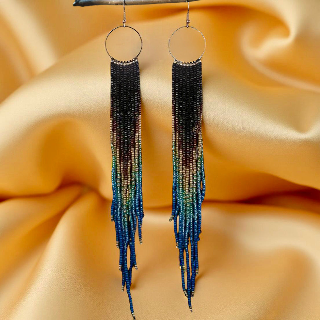 Handmade beaded earrings with extra-long fringe, featuring a black-to-blue gradient design and hypoallergenic 316L surgical steel lever backs.