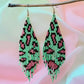 Handmade beaded earrings with green and pink leopard print design, featuring fringe detail and hypoallergenic 316L surgical steel lever backs, displayed against a pastel background.