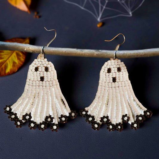 Handmade beaded earrings in the shape of cute white ghosts with black facial details and floral black fringe, perfect for Halloween and spooky season style.