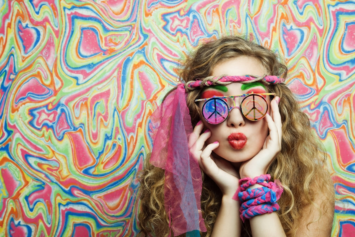 Hippie Wonkiwear woman with peace sign kaleidoscope glasses, tie dye and a psychedelic background