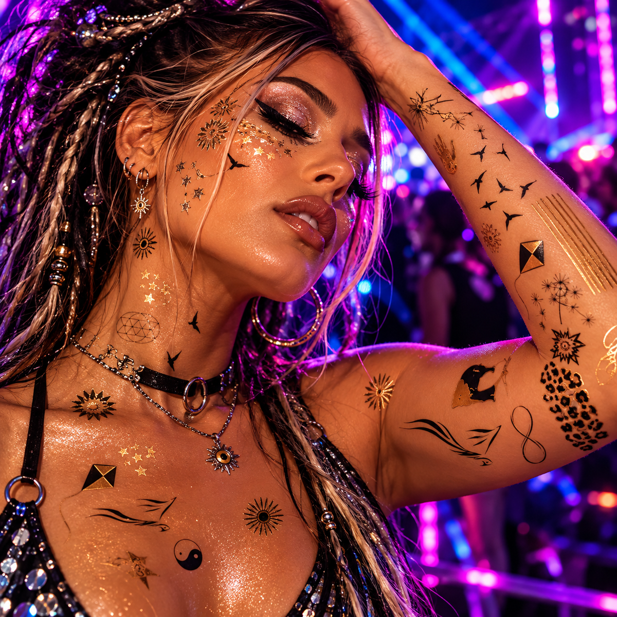 Person wearing gold and black metallic temporary tattoos at a neon-lit rave