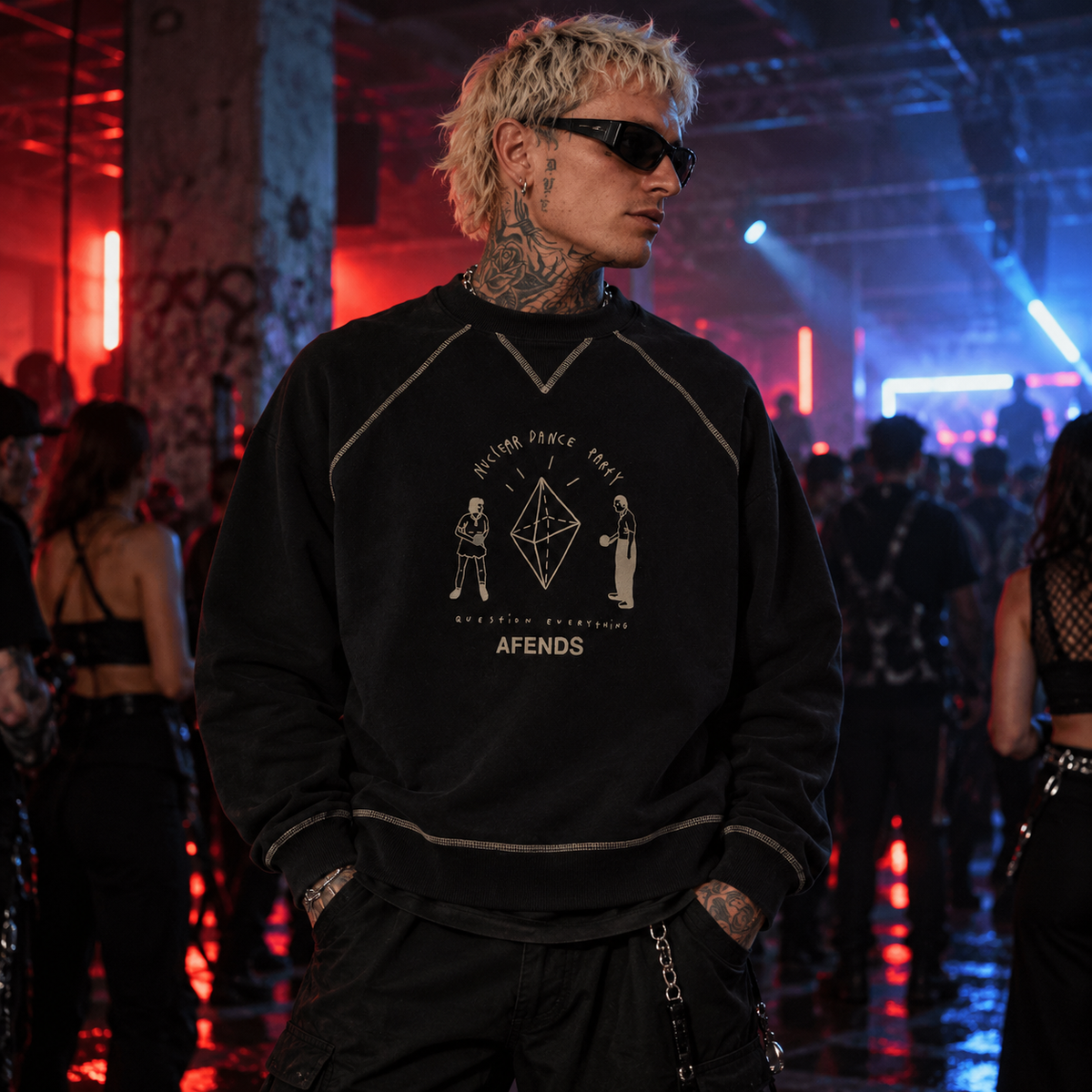 AFENDS black Nuclear Dance Party graphic sweatshirt with contrast stitching modelled by a man at an underground techno rave with red and blue lighting.