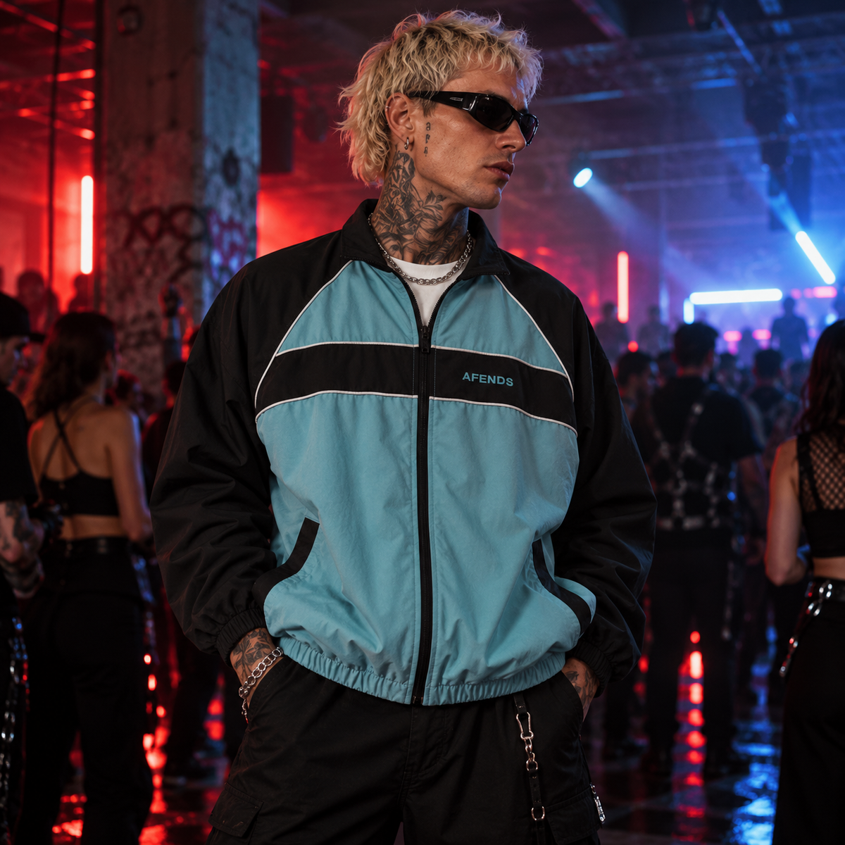 AFENDS Spicy Sports Spray Jacket in ocean spray blue and black styled at an underground UK techno rave with dramatic red and blue lighting.