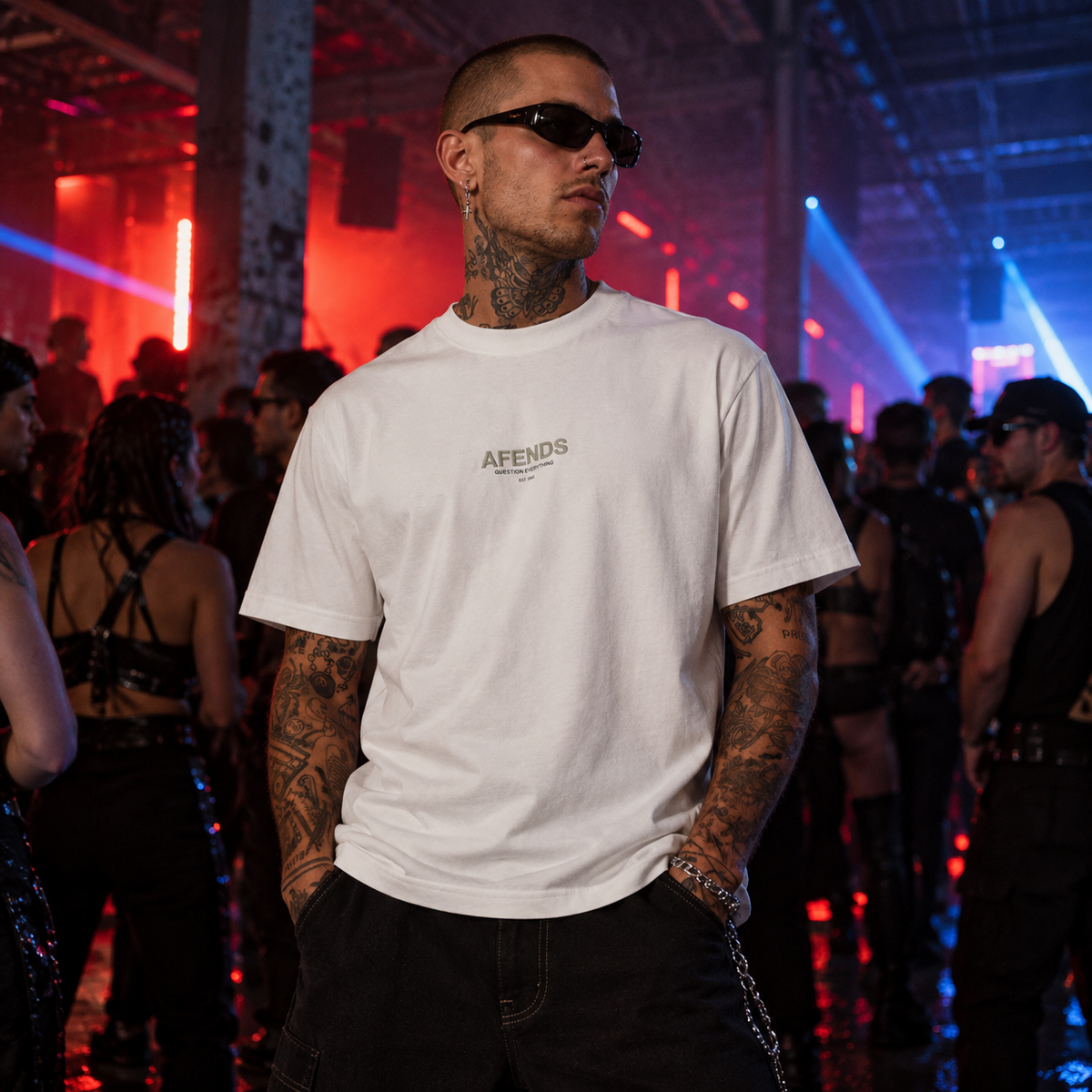 AFENDS white Vinyl Retro T-shirt with chest logo modelled at an underground UK warehouse rave with red and blue lighting.