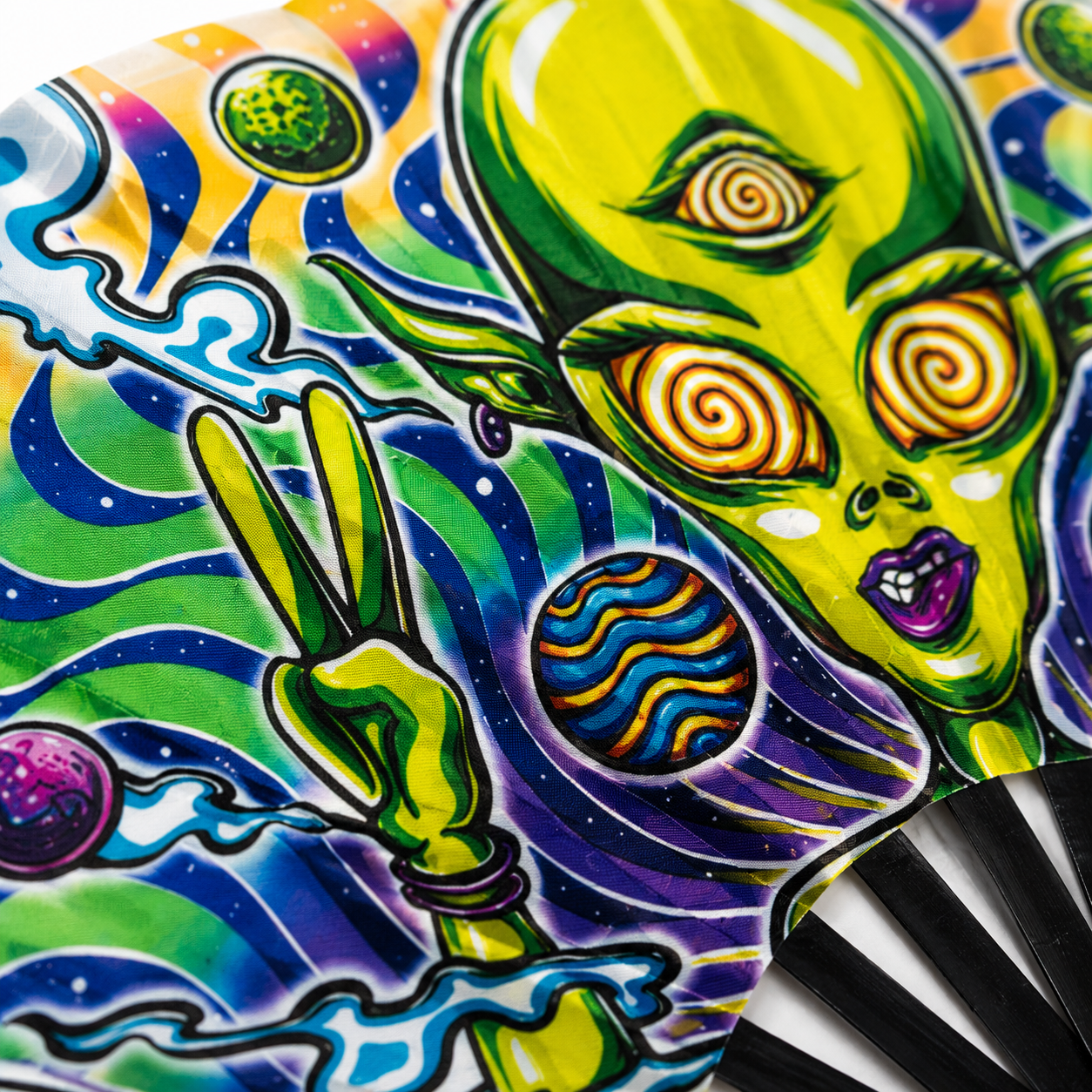 Close-up of psychedelic alien artwork printed on UV reactive silky festival fan