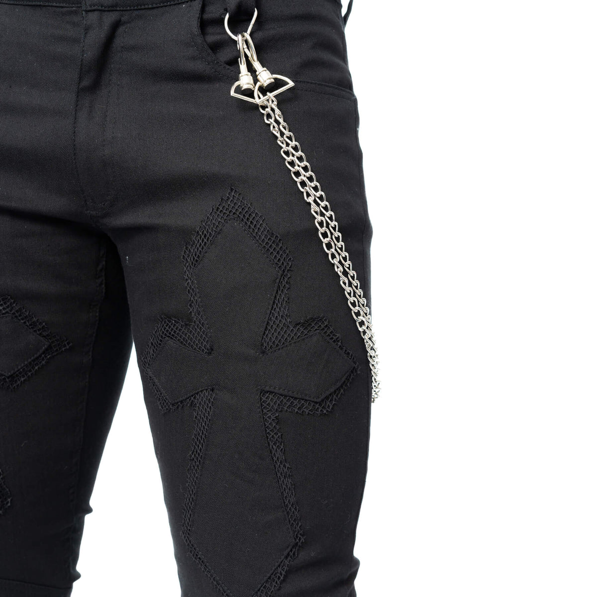 Close-up of the metal chain accent attached to the black trousers
