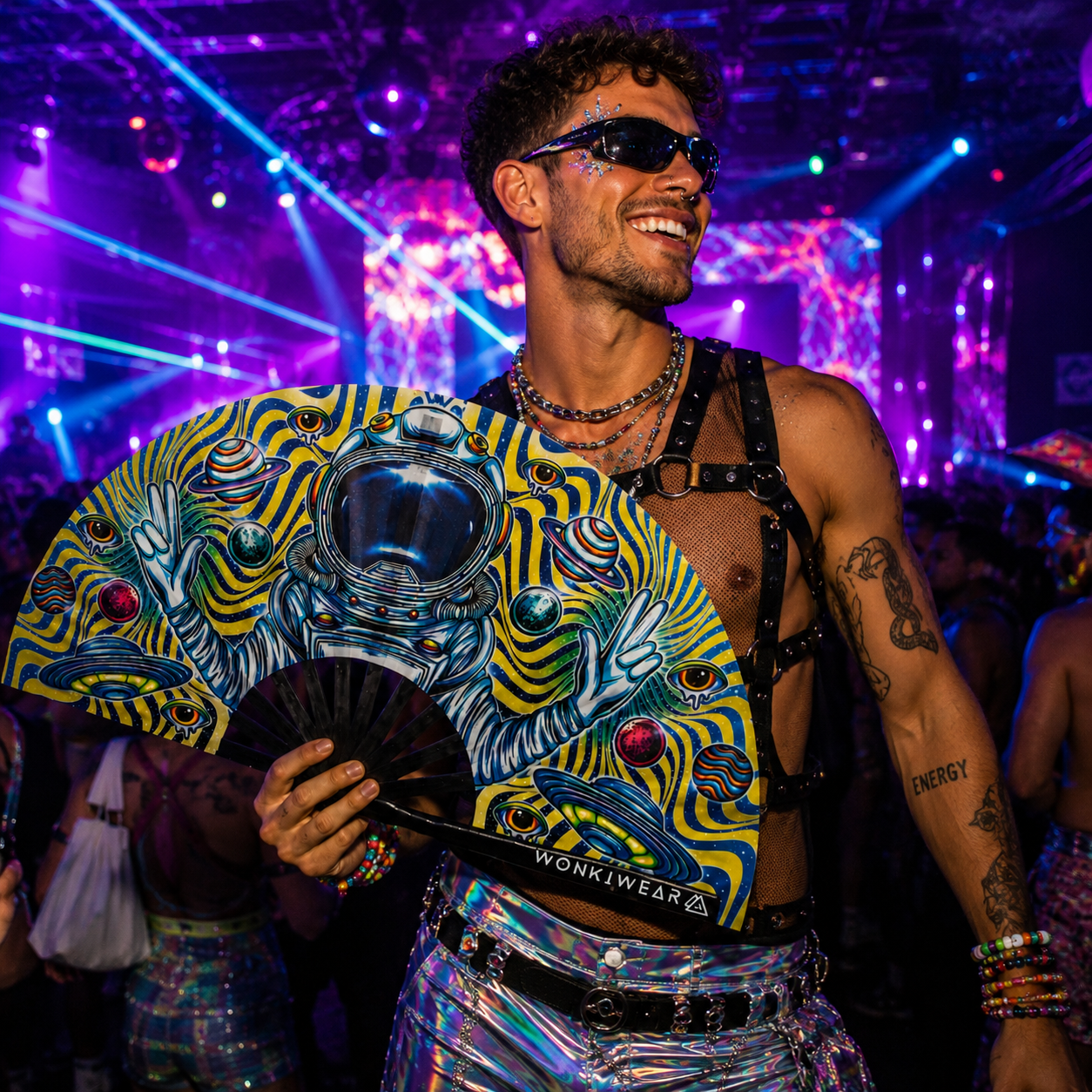 Male raver holding Astronaut Adventures XL folding fan inside nightclub rave