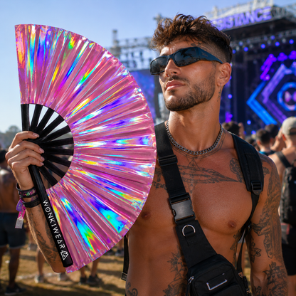 Male festival goer holding Aurora Galaxy pink iridescent XL festival fan