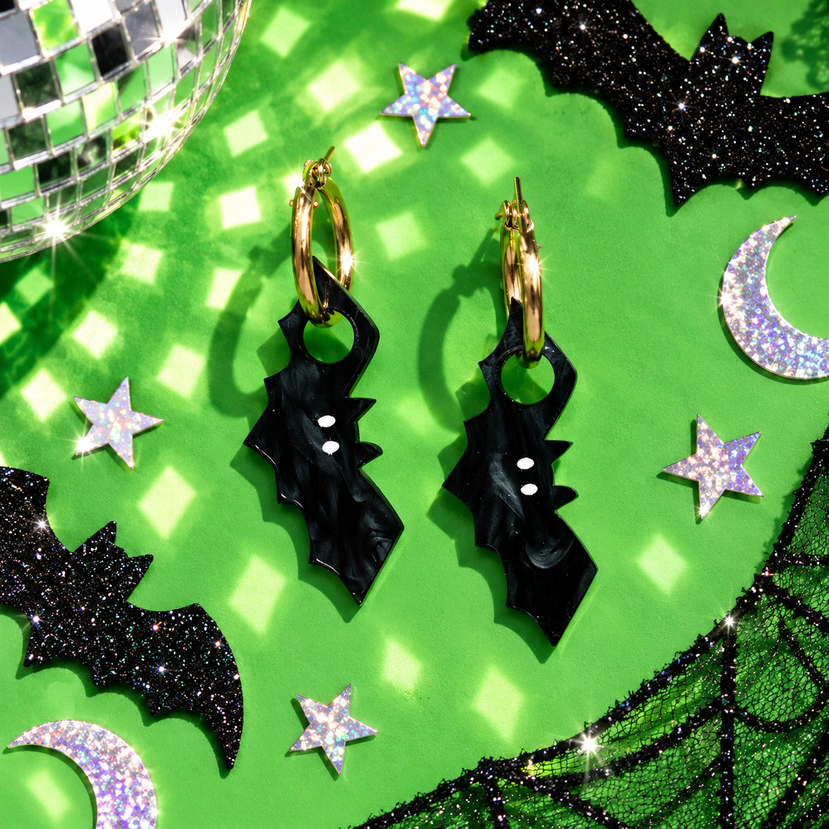 Black bat hoop earrings with dramatic wing-shaped acrylic charms by Cuteryko