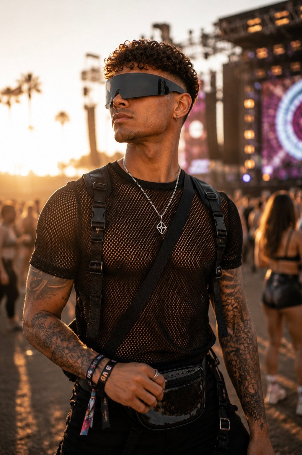 Male festival model wearing black futuristic shield sunglasses at music festival