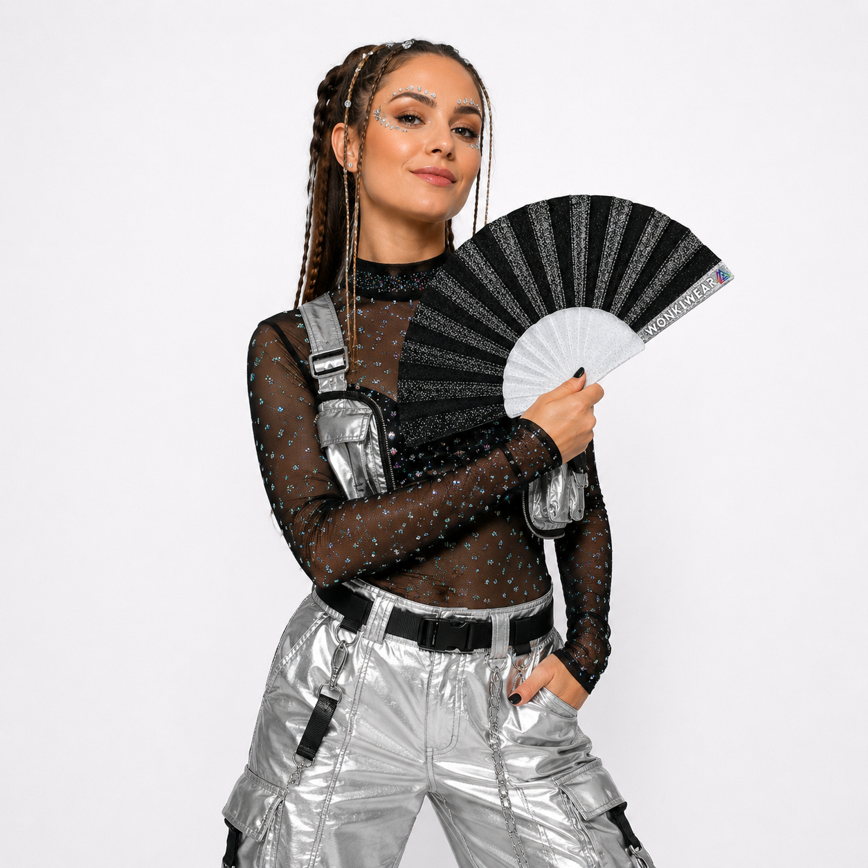 Fully clothed festival model holding a black glitter folding fan during a professional studio photoshoot