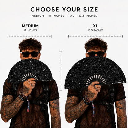 Size comparison of medium and XL black glitter festival fans held by model