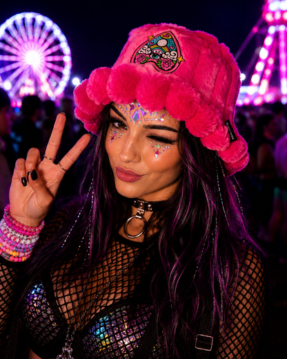 Woman wearing bright pink psychedelic furry bucket hat at nighttime festival