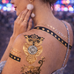 Model wearing chakra temporary tattoos for spiritual and boho festival makeup look