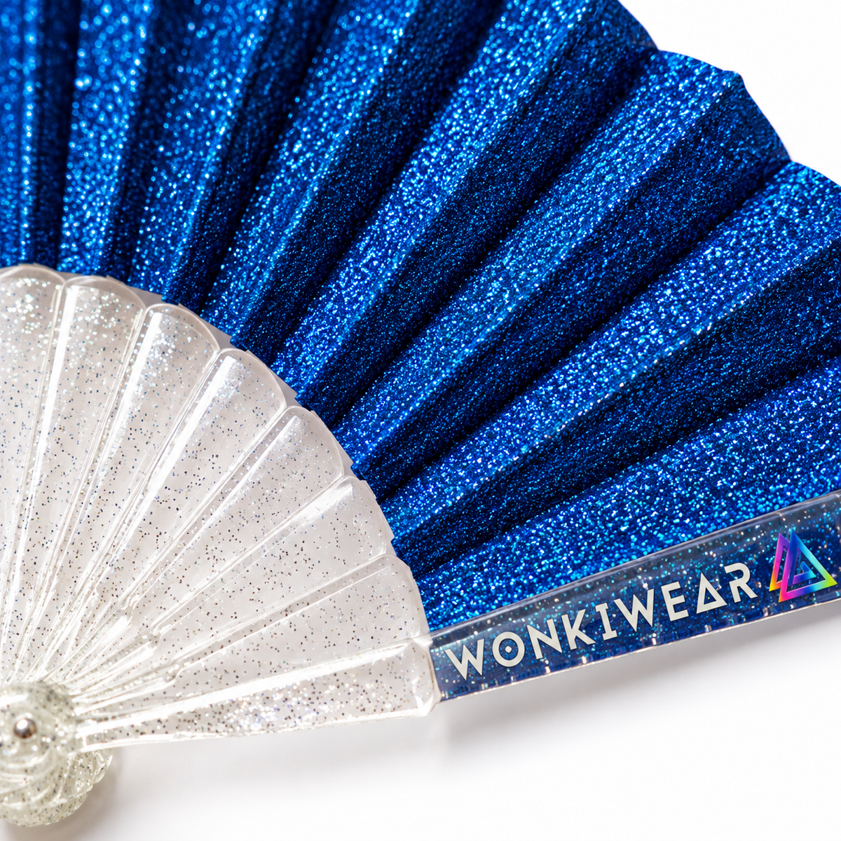 Close-up of cobalt blue glitter fan pleats, transparent glitter-speckled ribs and WonkiWear branding.