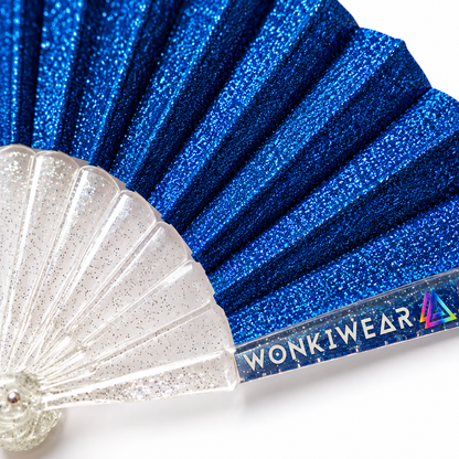 Close-up of cobalt blue glitter fan pleats, transparent glitter-speckled ribs and WonkiWear branding.
