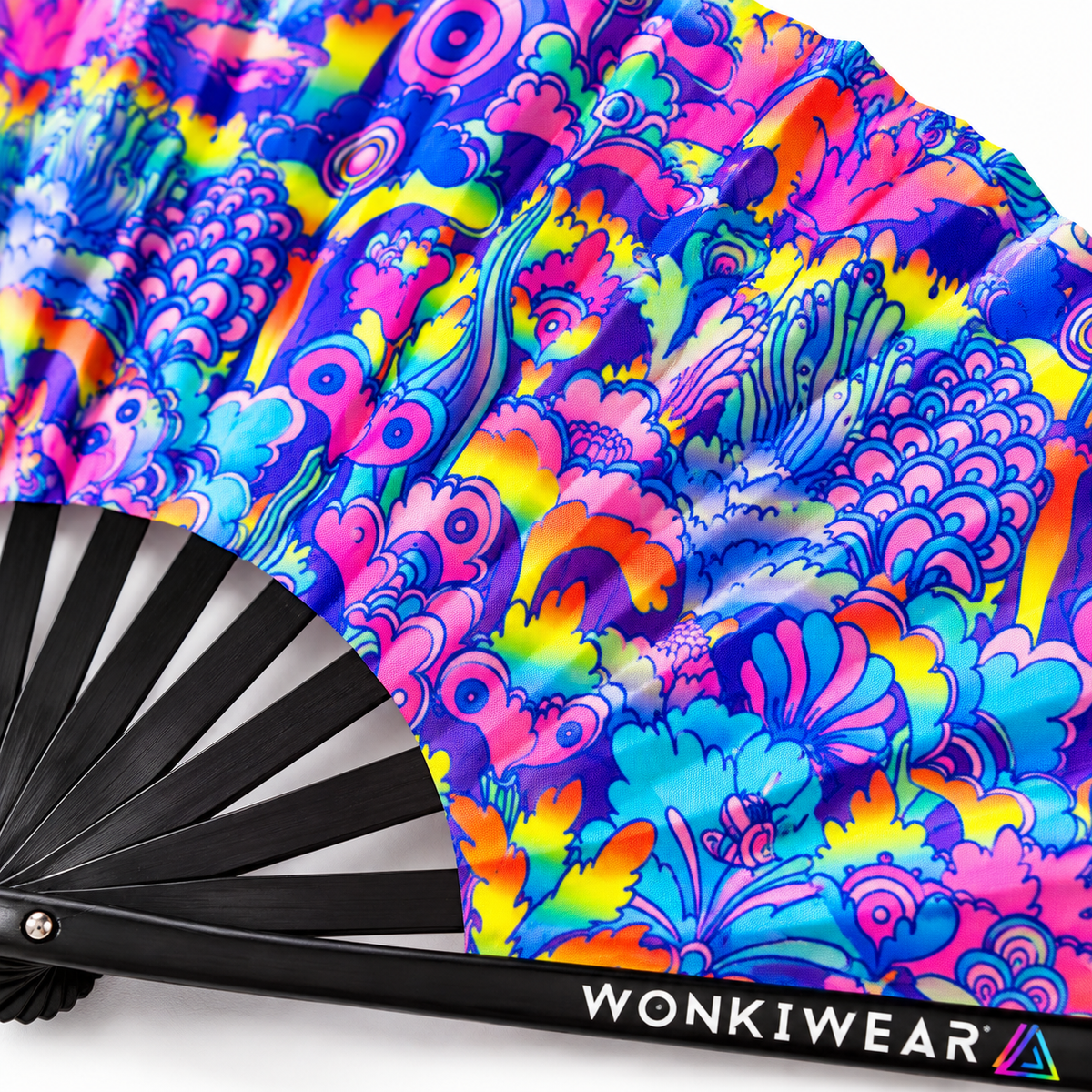 Close-up of the WonkiWear Cosmic Bloom XL folding fan showcasing its vibrant psychedelic floral pattern in pink, blue, purple and yellow, with detailed black ribs and colourful printed artwork.