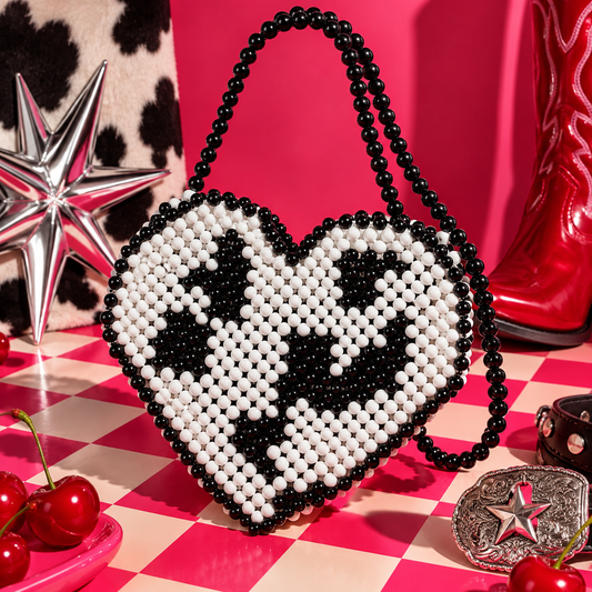 Black and white cow print heart-shaped bead bag with black beaded handle by Cuteryko