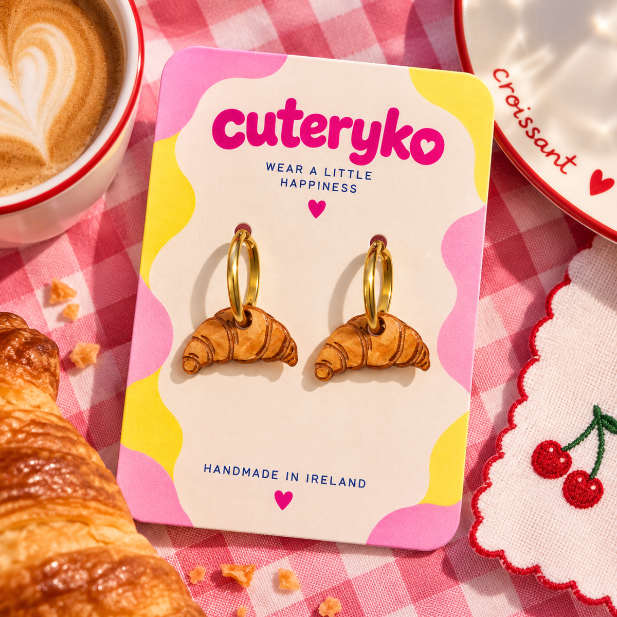 Croissant hoop earrings with detailed hand-painted pastry charms by Cuteryko