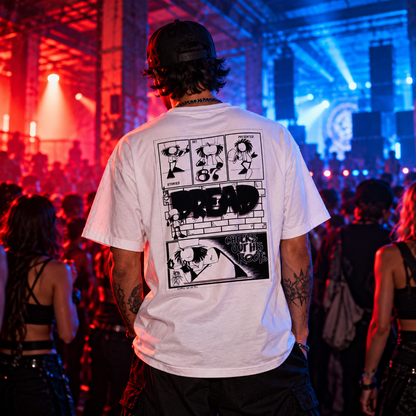 Man wearing the white Dready Walking Dread graphic T-shirt, showcasing its bold comic-style back print, at an underground drum and bass rave with red and blue warehouse lighting.