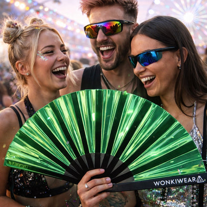 Group of friends at festival holding emerald iridescent rave fan by WonkiWear