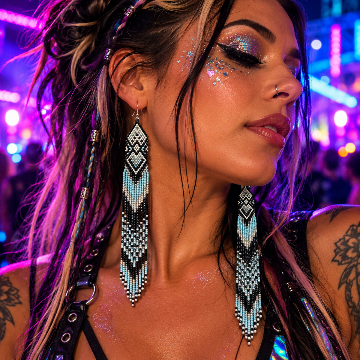 Woman wearing extra-long black, white and blue beaded fringe earrings at a neon rave festival