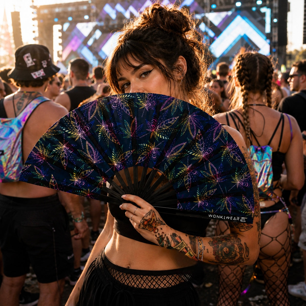 Lifestyle photo of model using WonkiWear UV reactive festival fan