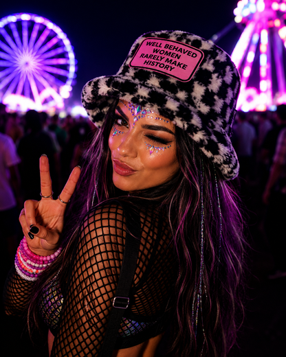 Festival model wearing black and white chequered furry bucket hat with statement slogan patch