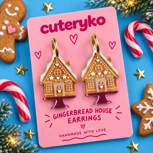 Gingerbread House hoop earrings with white icing details and pink bases by Cuteryko