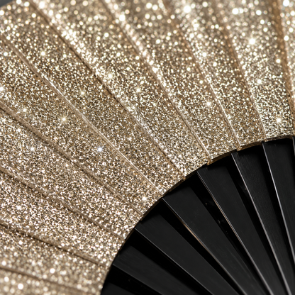 Close up glitter detail of gold festival folding fan
