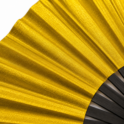 Macro close-up showing the metallic gold shimmer finish on XL festival fan