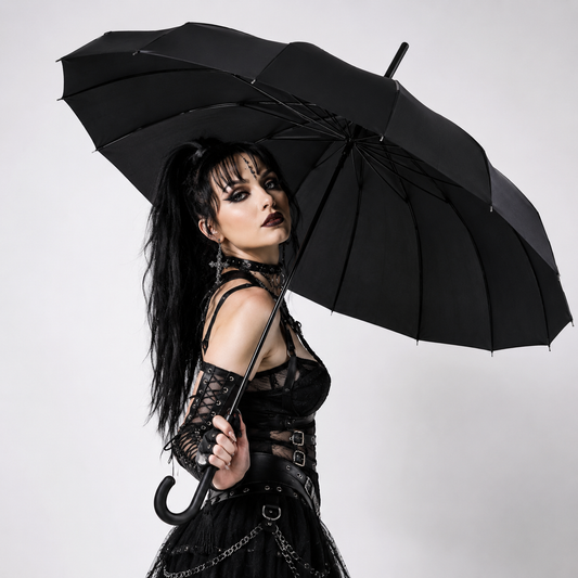 Gothic fashion model posing with black pagoda umbrella in studio setting