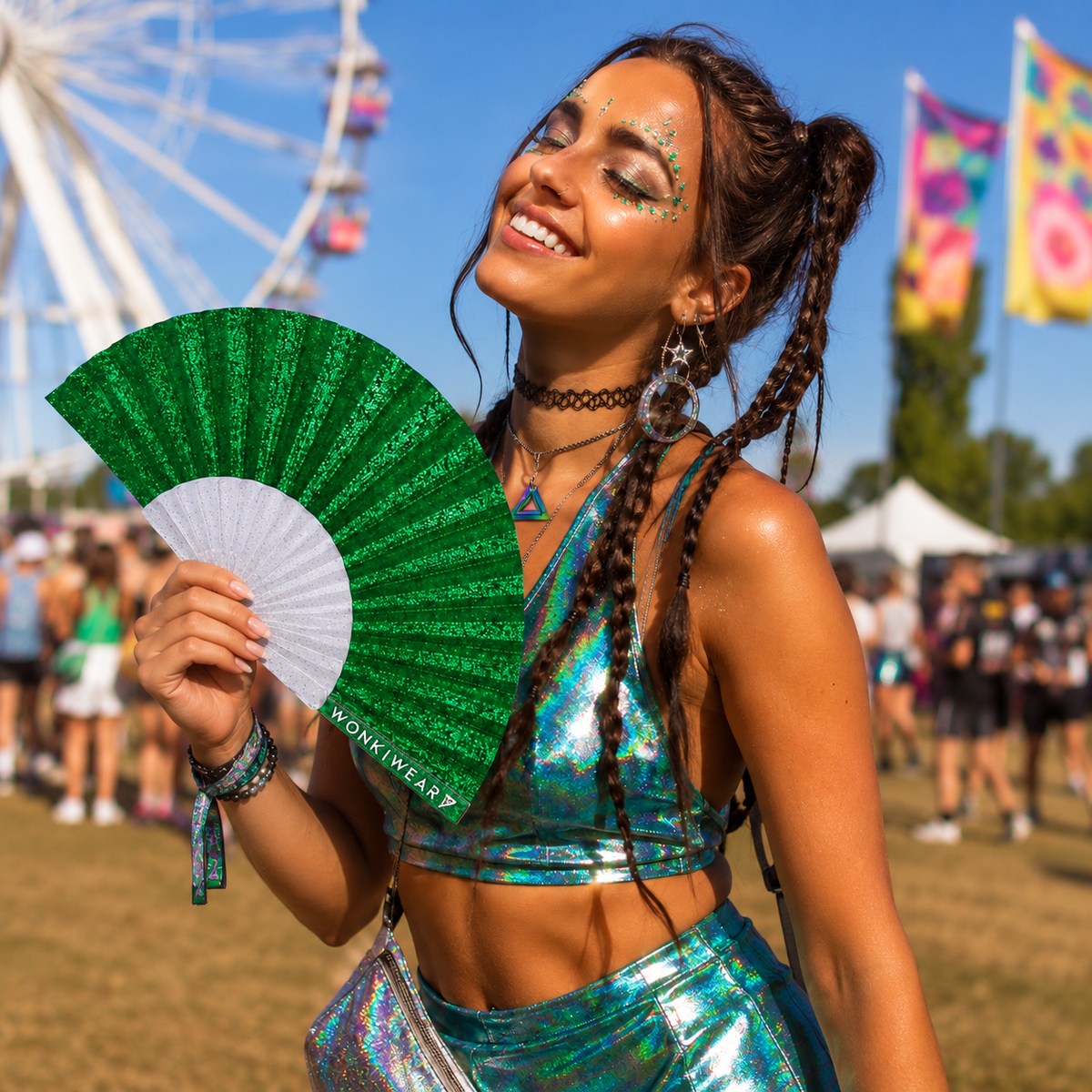Green glitter folding rave fan with WonkiWear branding held by a woman at a sunny festival