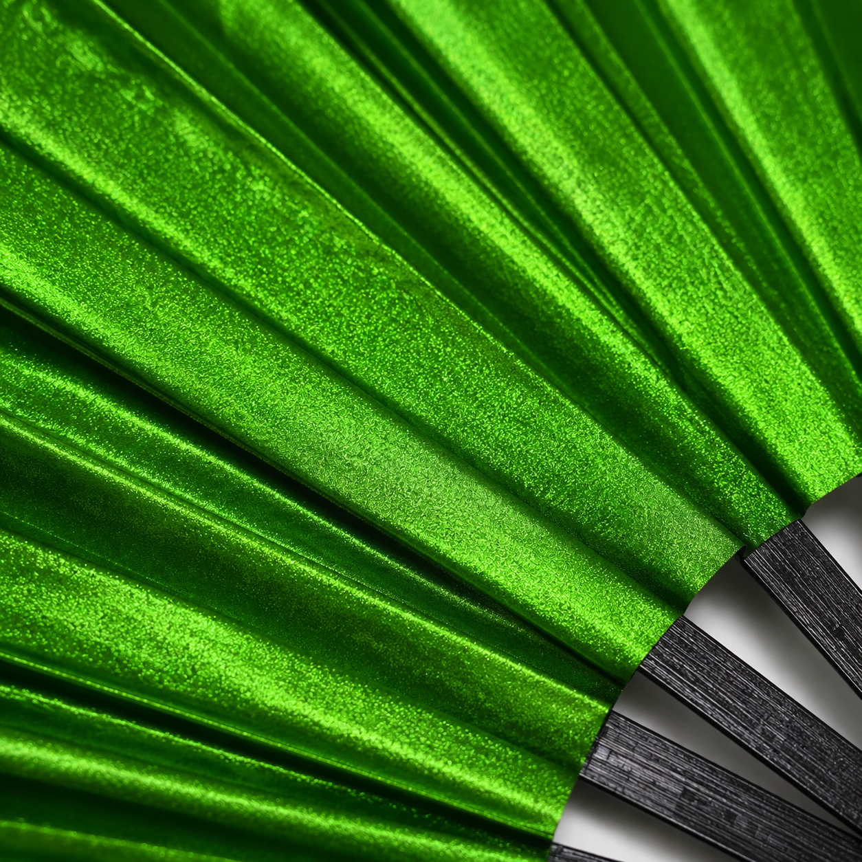Close-up showing metallic emerald green shimmer texture on WonkiWear XL festival fan