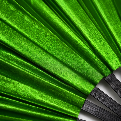 Close-up showing metallic emerald green shimmer texture on WonkiWear XL festival fan