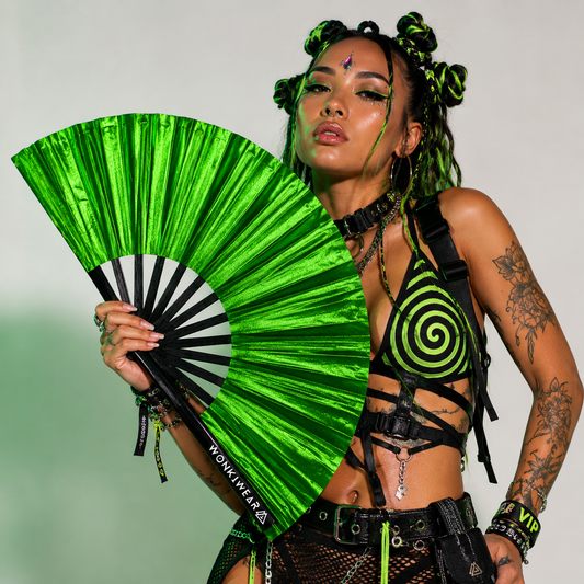 Festival model holding XL green shimmer metallic festival fan during studio photoshoot